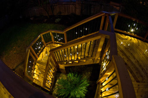 Deck stairs illuminated by balusters with LED lights